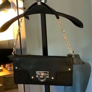 DKNY monogram fabric and leather bag with silver details.